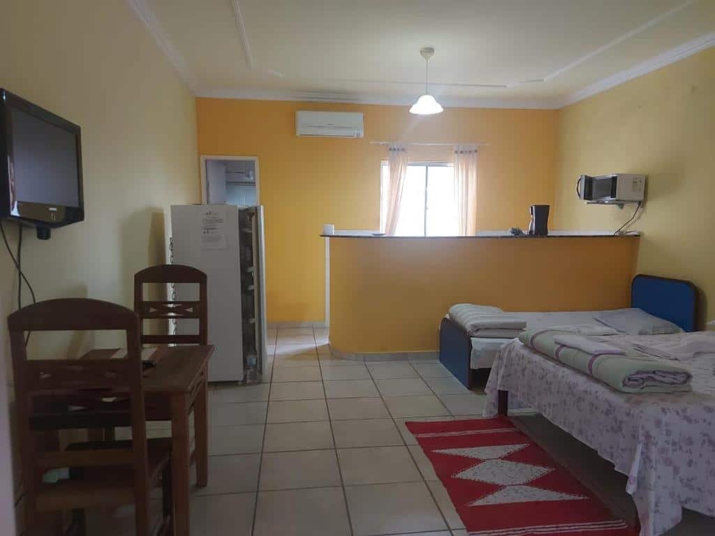 Quarto e cozinha do airbnb Encantu